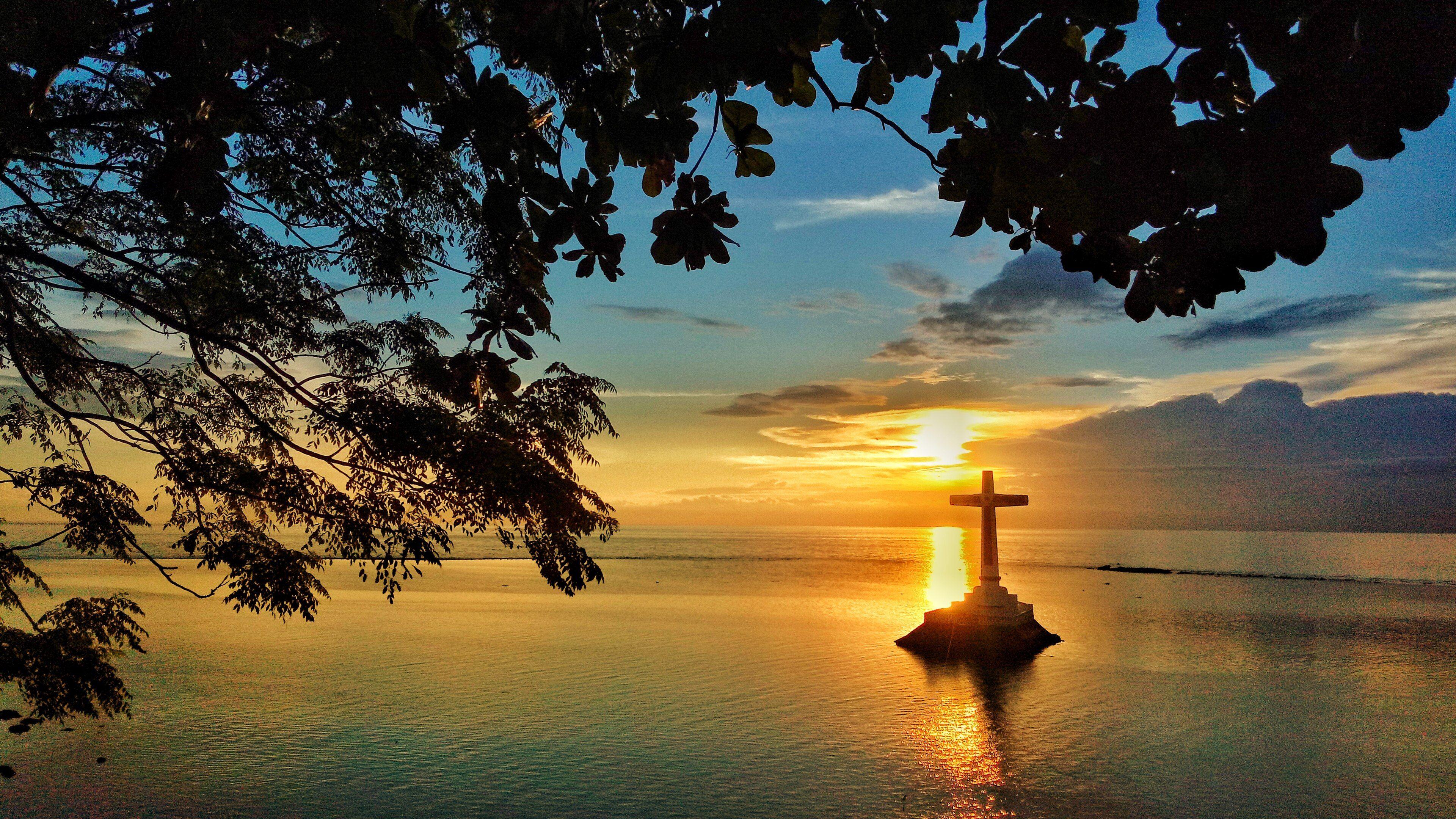 The white concrete memorial cross above the Sunken Cemetery, Camiguin Island.
